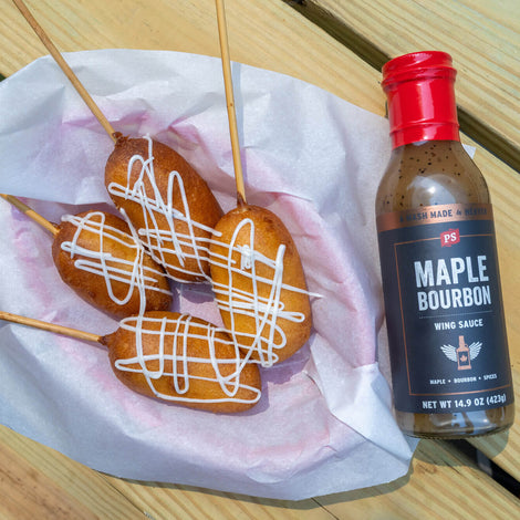 Deep Fried Cheesecake on a Stick in a basket with maple bourbon wing sauce
