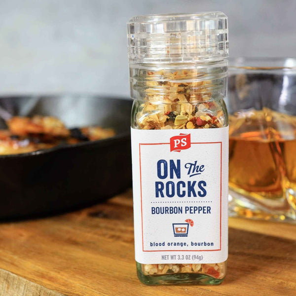 Image of On the Rocks - Bourbon Pepper Seasoning, in front of a dish and a glass of bourbon.