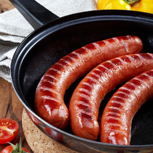 Three Cajun Sausage's sizzling in the pan