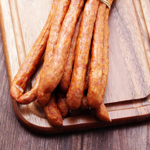 PS Seasonings Willie's Snack Stick laying on a cutting board.
