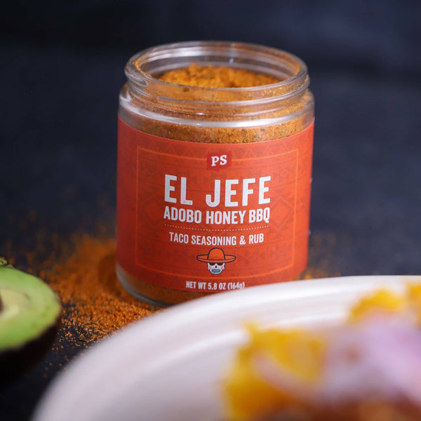 An open can of El Jefe with seasoning on the table behind a plate.