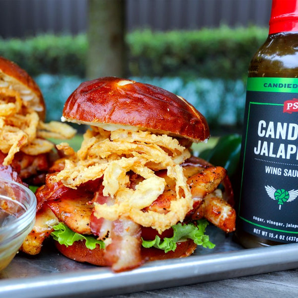 Candied Jalapeno Chicken Sandwhich next to a bottle of Candied Jalapeno.
