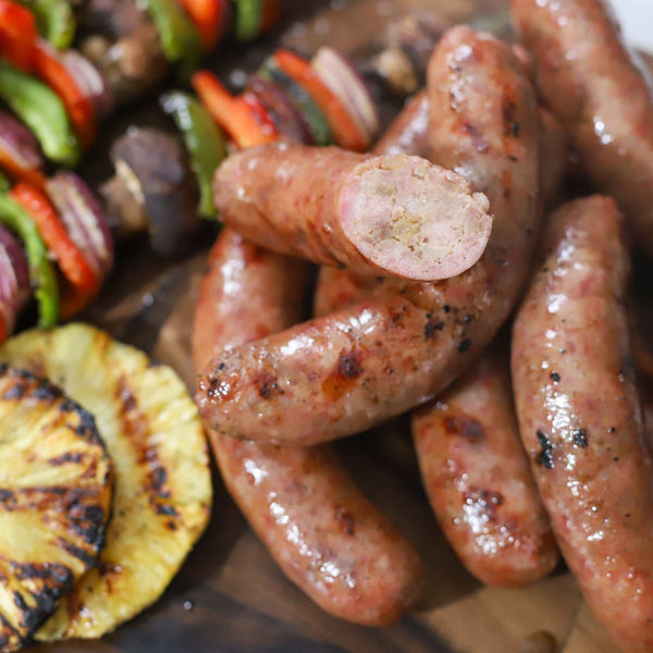 Pineapple Teriyaki Brats with cabobs and pineapple slices.