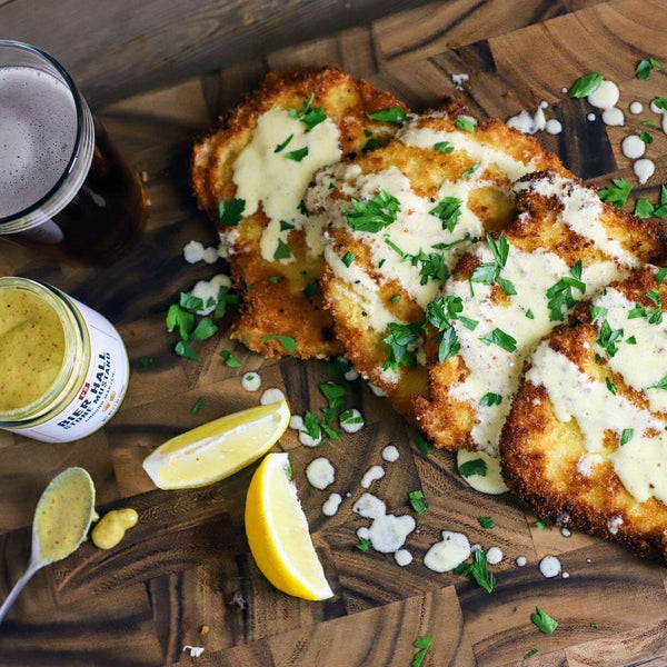 Pork Schnitzel with Lemon Mustard Cream. This is next to an open jar of Bier Hall Bavarian Ale Mustard 