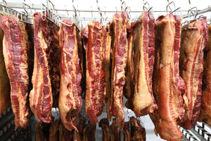 Meat made with PS Seasonings Maple Meat Cure hanging from a rack.