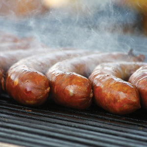 Hot Italian Sausages sizzling on the grill.