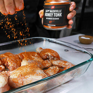 Chicken being covered in Honky Tonk - Nashville Hot Seasoning 