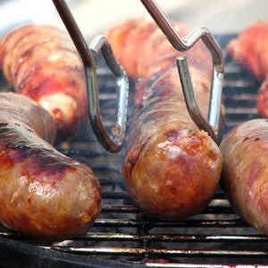 Sweet Italian Sausage's sizzling on the grill made with PS Seasonings Sweet Italian Sausage Seasoning.