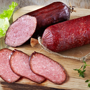Two Summer Sausages with three slices front and center.