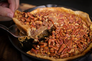 Smoked pecan pie with golden filling and toasted pecan topping