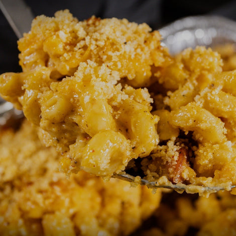 Andouille smoked mac n cheese in a foil pan fresh off the smoker with golden breadcrumb topping