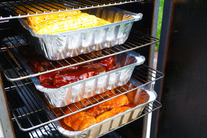 Labor Day BBQ spread with smoked party ribs, hot honey corn on the cob, and smoked chicken breasts