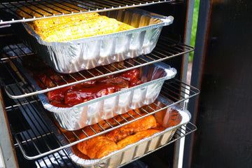 Labor Day BBQ spread with smoked party ribs, hot honey corn on the cob, and smoked chicken breasts