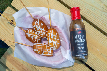 Deep Fried Cheesecake on a Stick in a basket with maple bourbon wing sauce