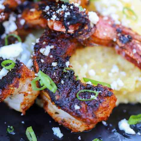 blackened shrimp on top of cotija polenta