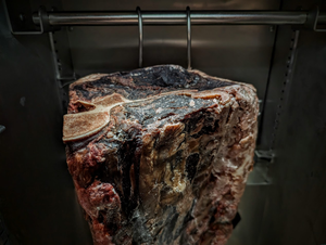 Dry aged beef primal cuts on a rack