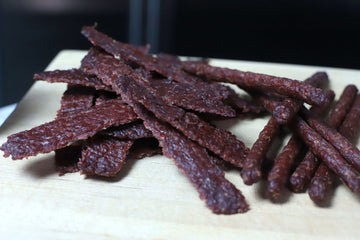 Homemade beef jerky made with no dehydrator or smoker — ground beef rolled with a rolling pin and dried on a rack in a conventional oven