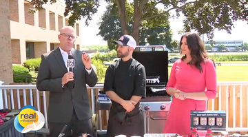 Three people at a TV interview on a deck grilling