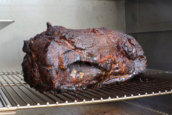 smoked pork butt in a smoker