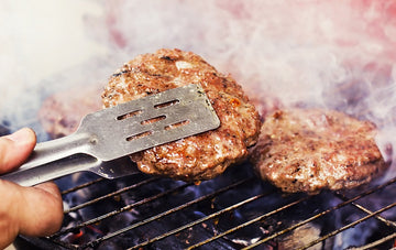 grilling burgers on the barbecue at a tailgate party