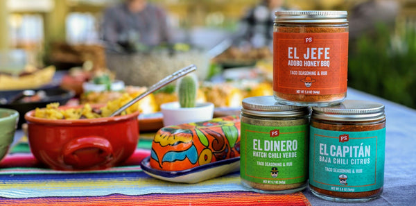 jars of taco seasonings on table full of food