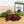 A packaged jerky kit box labeled 'Candied Jalapeño Jerky' stands on a wooden cutting board next to sliced jerky pieces