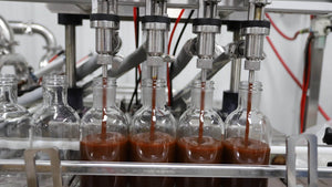 Bottles being filled with PS Seasoning sauces 