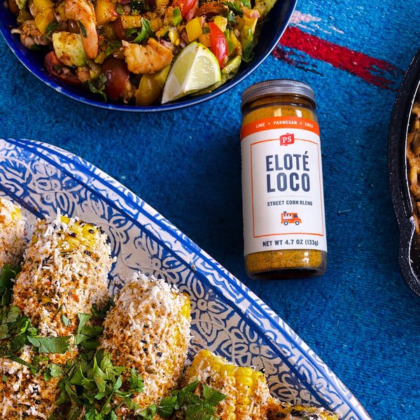 Elote Loco - Street Corn Seasoning on table with corn and shrimp