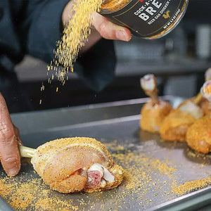 Cock-a-Doodle Brew BBQ Rub shaken on chicken