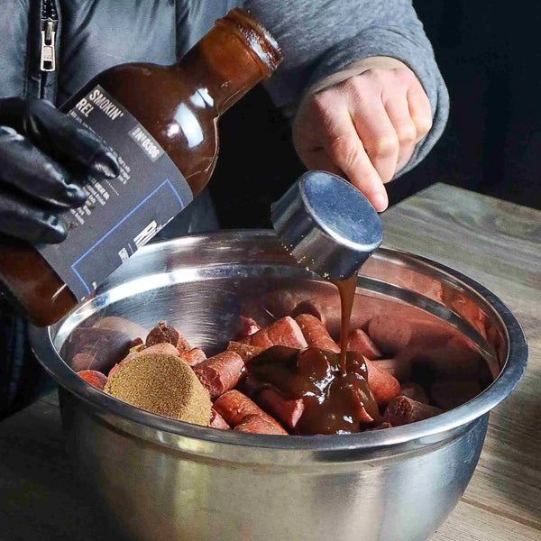 Blue Ribbon BBQ Sauce being poured into a bowl of wieners