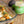 Jar of 'El Dinero' Hatch Chili Verde seasoning with a dish of taco ingredients on a wooden surface.