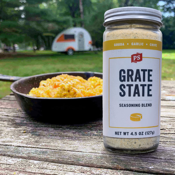 Grate State seasoning blend jar with a bowl of food outdoors