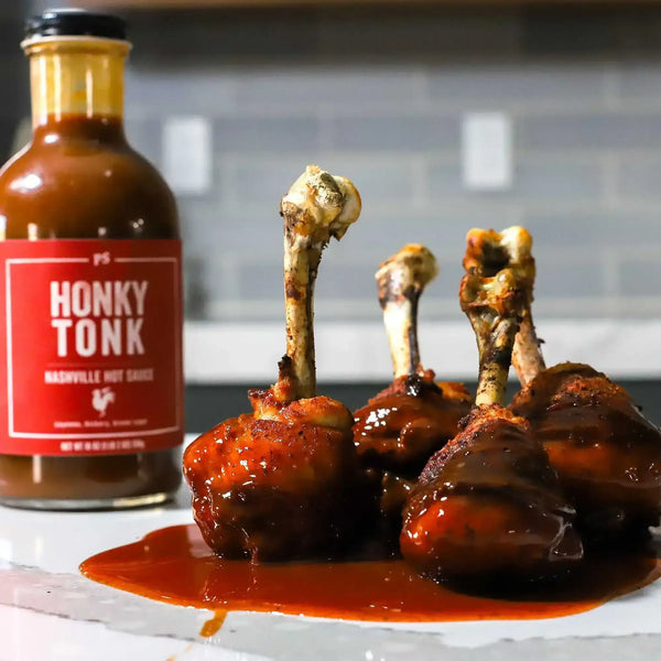 Nashville Hot Chicken Lollipops with a bottle of Honky Tonk next to them.