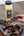 Person holding a rib next to a bottle of Jackpot Cooking Oil on a wooden table.