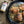 Skillet of chicken with a jar of King Shallot seasoning on a wooden surface