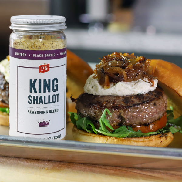 Burger with King Shallot seasoning blend on a wooden surface