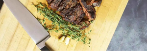 Prime Time - Buttery Beef Rub on butcher block with steak