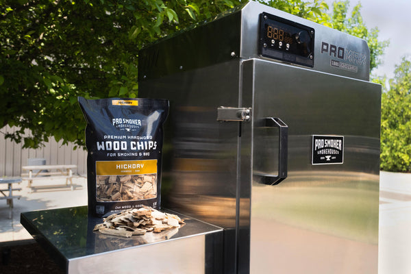 PS Seasoning Pro Smoker premium smoking wood chips — Hickory pictured next to a Pro Max 100 S vertical electric smoker