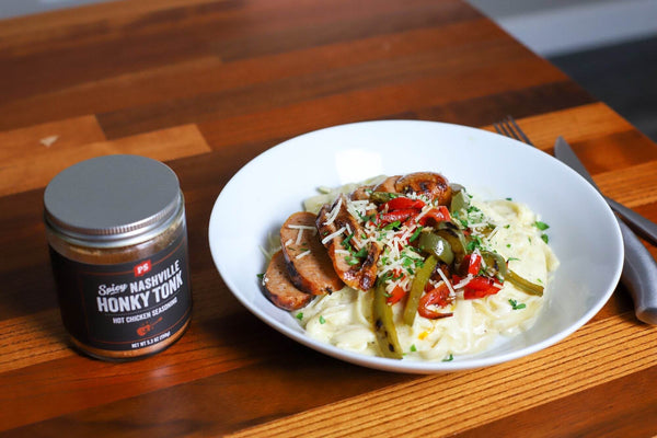 Honky Tonk - Nashville Hot Seasoning in jar next to dish