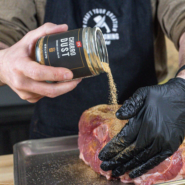 Churro Dust rub being sprinkled on pork