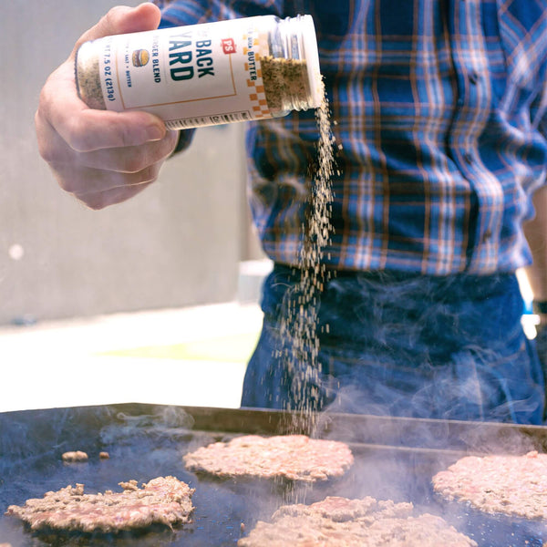 The Backyard Buttery Burger Seasoning sprinkled on burgers