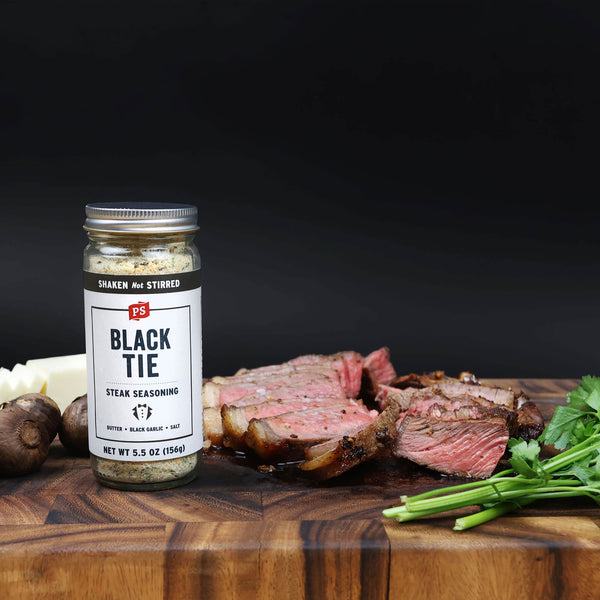 Black Tie Butter, Black Garlic, and Salt seasoning shaker with steak