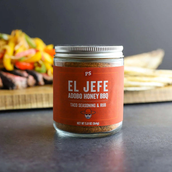 El Jefe - Adobo Honey Taco Seasoning & Rub in glass jar with food behind