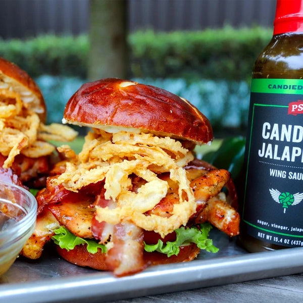Candied Jalapeno Wing Sauce next to chicken sandwich