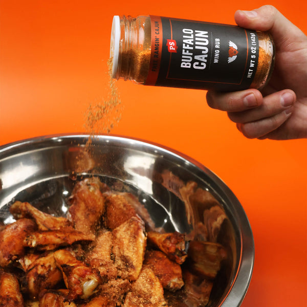 Buffalo Cajun Wing Rub sprinkled on a bowl of chicken wings