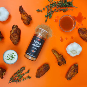 Buffalo Cajun Wing Rub bottle with chicken wings