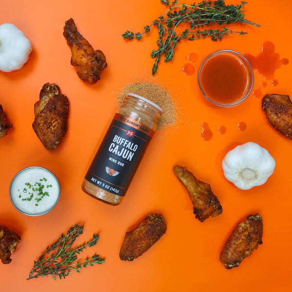 Buffalo Cajun Wing Rub bottle with chicken wings