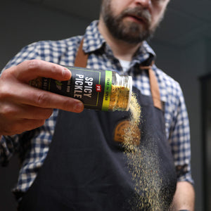 Spicy Dill Pickle Wing Rub sprinkling out of shaker bottle