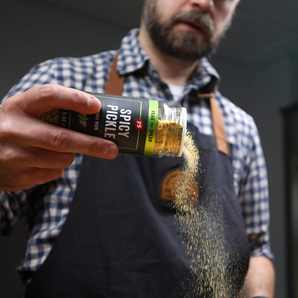Spicy Dill Pickle Wing Rub sprinkling out of shaker bottle