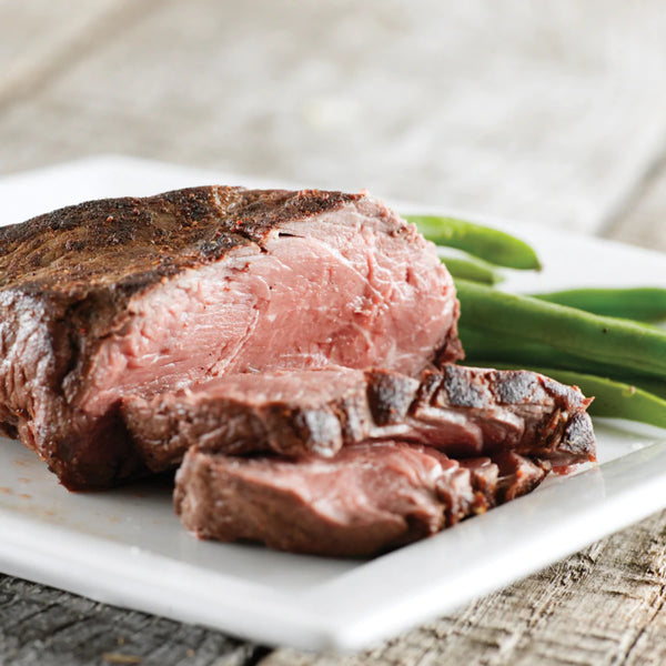 Roast Beef made with PS Seasonings Roast Beef Seasoning next to green beans.
